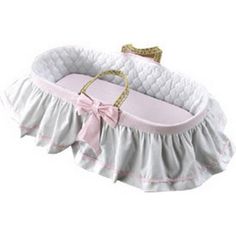 a baby crib with a pink bow on it