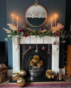 a living room with a fire place and decorations on the mantel above it's mantle