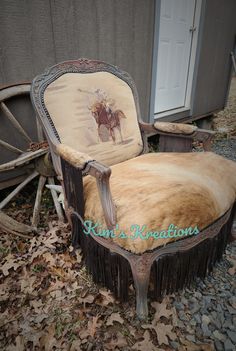 an old chair that is sitting on the ground in front of a building with a horse drawn