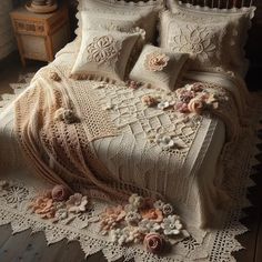 a crocheted bedspread with flowers on it and a lace doily