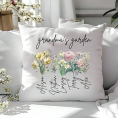 a white pillow with flowers and writing on it