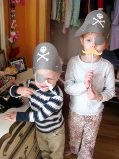 two children wearing pirate hats and mustaches