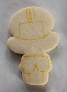 two cookies with yellow lines on them sitting next to each other in the shape of a man's head