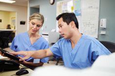 two doctors looking at something on a tablet