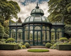 a green glass house surrounded by trees and bushes in the middle of a garden area