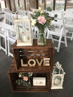 a wooden shelf with flowers and pictures on it