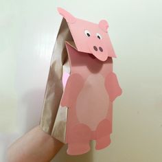 someone is holding up a paper bag with a pig on it