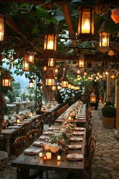 an outdoor dining area with many tables and chairs, lit by lanterns hanging from the ceiling