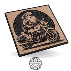 an image of santa claus on a motorcycle carved into wooden plaque with the words merry christmas