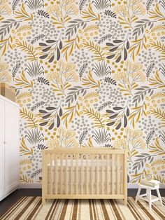 a baby's room with yellow and gray wallpaper