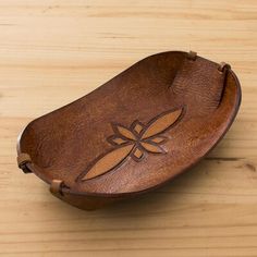 a wooden bowl with a dragonfly design on it