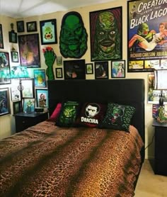 a bedroom with posters on the wall and pictures on the walls above it, along with a bed covered in leopard print