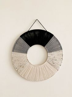 a black and white circle hanging on the wall