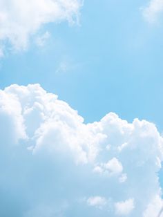 an airplane flying high in the sky with clouds behind it and a jet trail going through the air