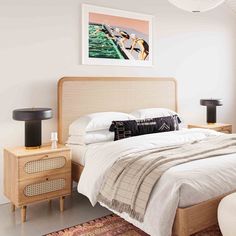 a bedroom with a bed, two nightstands and a painting on the wall above it