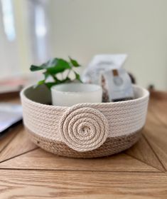 a white knitted bowl with a flower on it