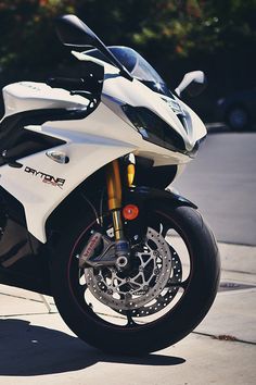 a white and black motorcycle parked on the street