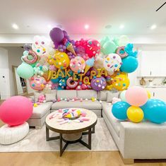 a living room decorated with balloons and confetti