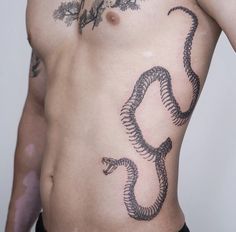 a man with a snake tattoo on his chest