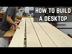 a man working on a desk with the words how to build a desk top in front of him