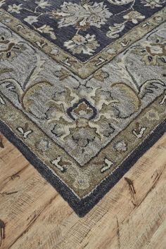 an area rug is shown on the floor with wood floors and parquets in the background