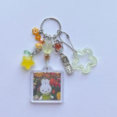 a keychain with an image of a hello kitty and other items on it