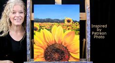 a woman is holding up a painting with sunflowers in the background and an easel behind her