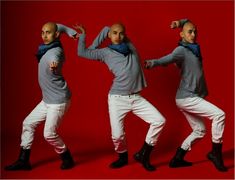 three men in white pants and grey sweaters are posing with their arms behind their backs