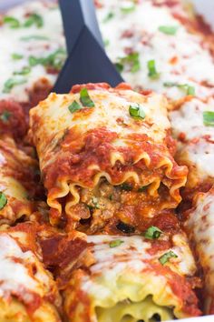 a pan filled with lasagna shells covered in sauce and cheese