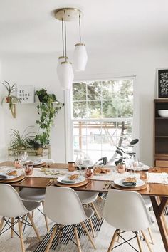 a dining room table with plates and cups on it