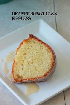 an orange bundt cake is on a white plate