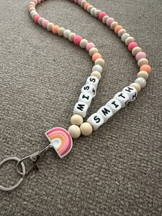 a lanyard that has some beads on it and is attached to a keychain