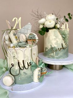 two decorated cakes sitting on top of a table