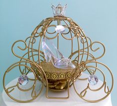 a gold and white birdcage with high heels on top