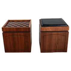 two wooden boxes with chess boards on top of each one, side by side in front of white background