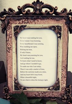 an ornate frame with a poem in it on a table next to a flower pot