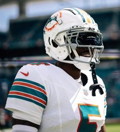 a miami dolphins football player wearing a helmet