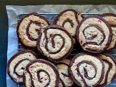 there are many cookies that have been made in the shape of spirals on a cooling rack