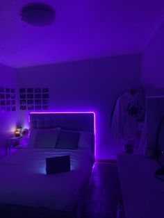 a bed in a room with purple lighting