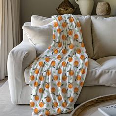 an orange print blanket draped over a couch