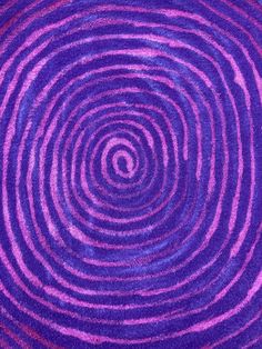 an abstract purple and pink background with spirals in the center, made from yarn