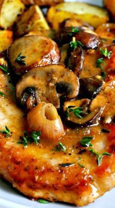 chicken with mushrooms and lemons on a white plate, garnished with parsley