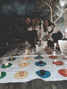 a group of women sitting around a table with drinks on it