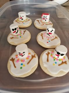 frosted decorated cookies in the shape of snowmen