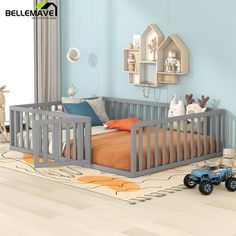 a child's bedroom with blue walls and wooden furniture, including a toy truck