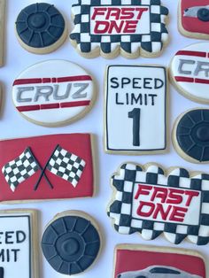 decorated cookies with racing themed frosting on white paper and black and red icing