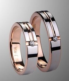 two gold wedding rings with diamonds on them