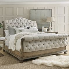 a bedroom with a bed, dresser and mirror in it's centerpieces