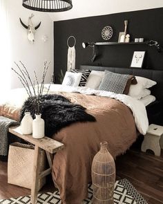 a bed room with a neatly made bed next to a window and a birdcage