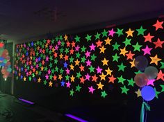 the wall is decorated with stars and balloons